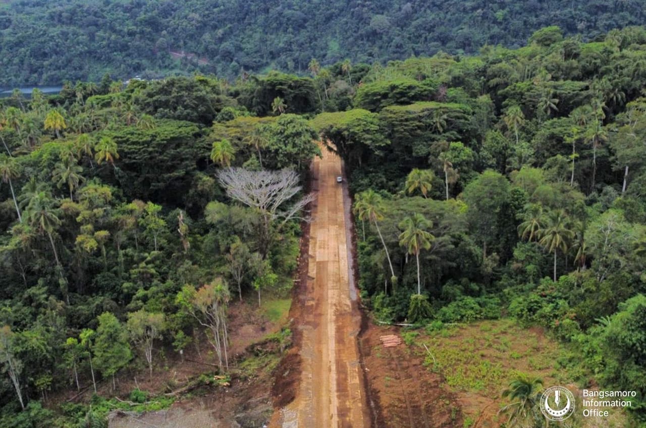 Aerial view of a new BARMM-funded road through the forested hills of Bayang