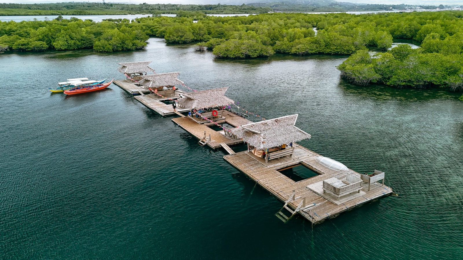 Thatched floating cottages linked by boardwalks sit among the mangroves at Marang-Marang.